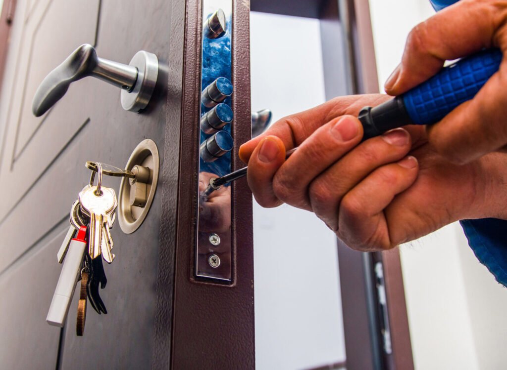 Locksmith working on door lock