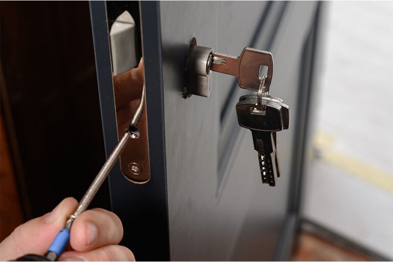 Locksmith working on door lock